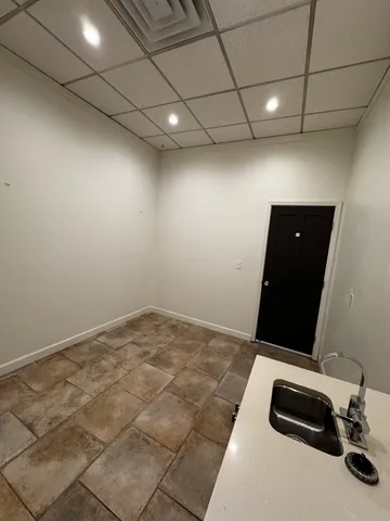 a room with a bed and a computer on the desk