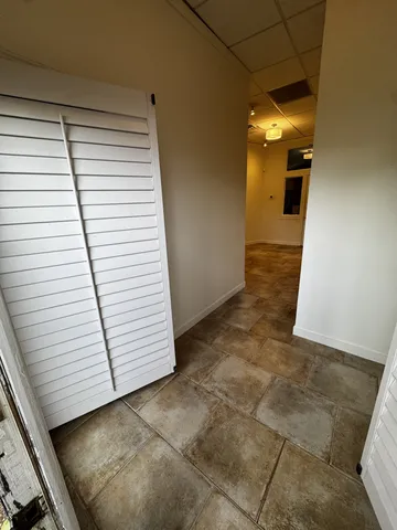 a view of a room with white walls and tiles