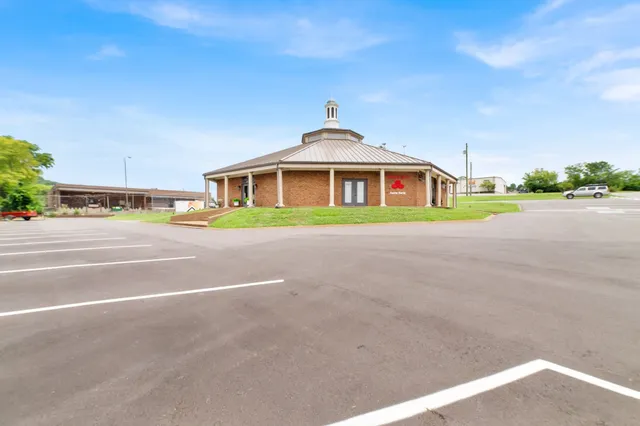 a front view of a house with a yard and potted plants