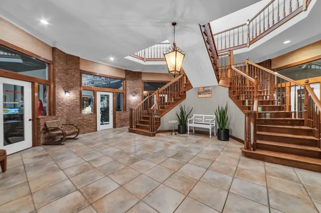 a lobby with furniture and a rug