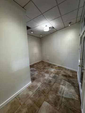 an empty room with a empty space and windows