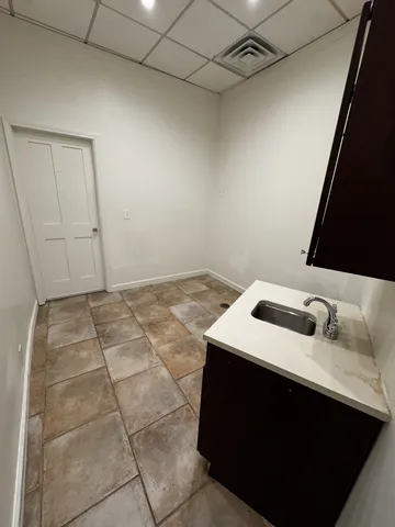 a bathroom with a sink vanity and tub
