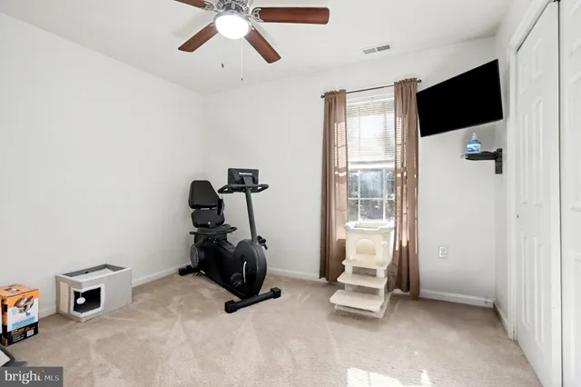 a room with gym equipment and a flat screen tv