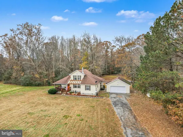 a view of a house with a yard and wooden fence
