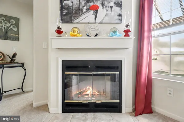 a utility room with a fireplace and cabinets