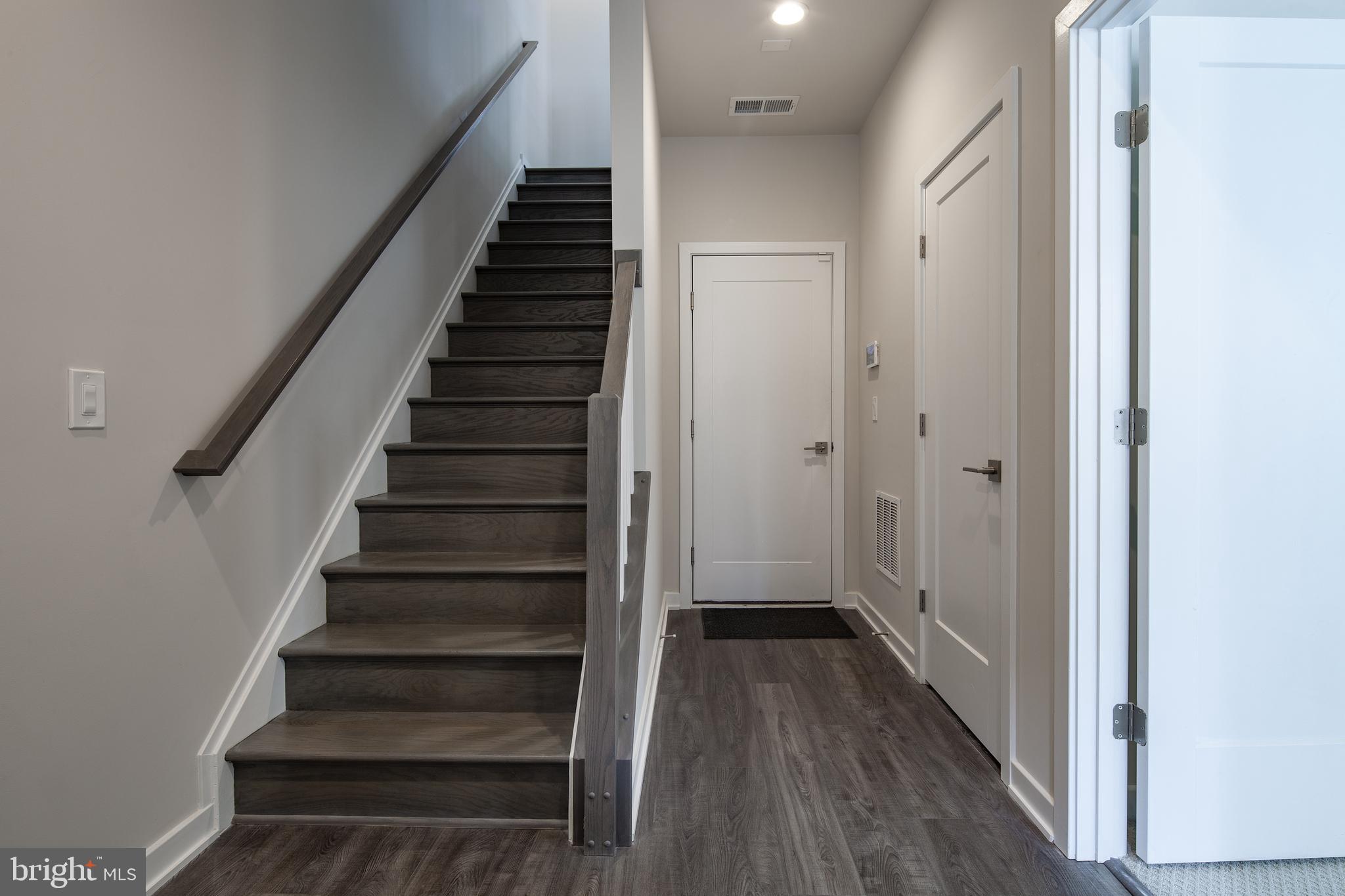 1770 Violet Ridge Place McLean, VA 22102 - Photo 13 of 54 a view of a hallway with wooden floor and entryway