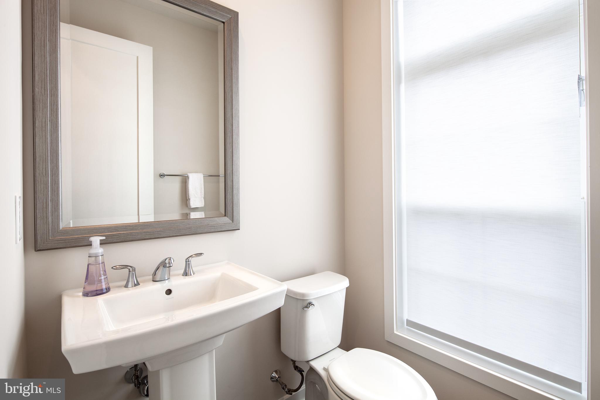 1770 Violet Ridge Place McLean, VA 22102 - Photo 25 of 54 a bathroom with a sink mirror and toilet