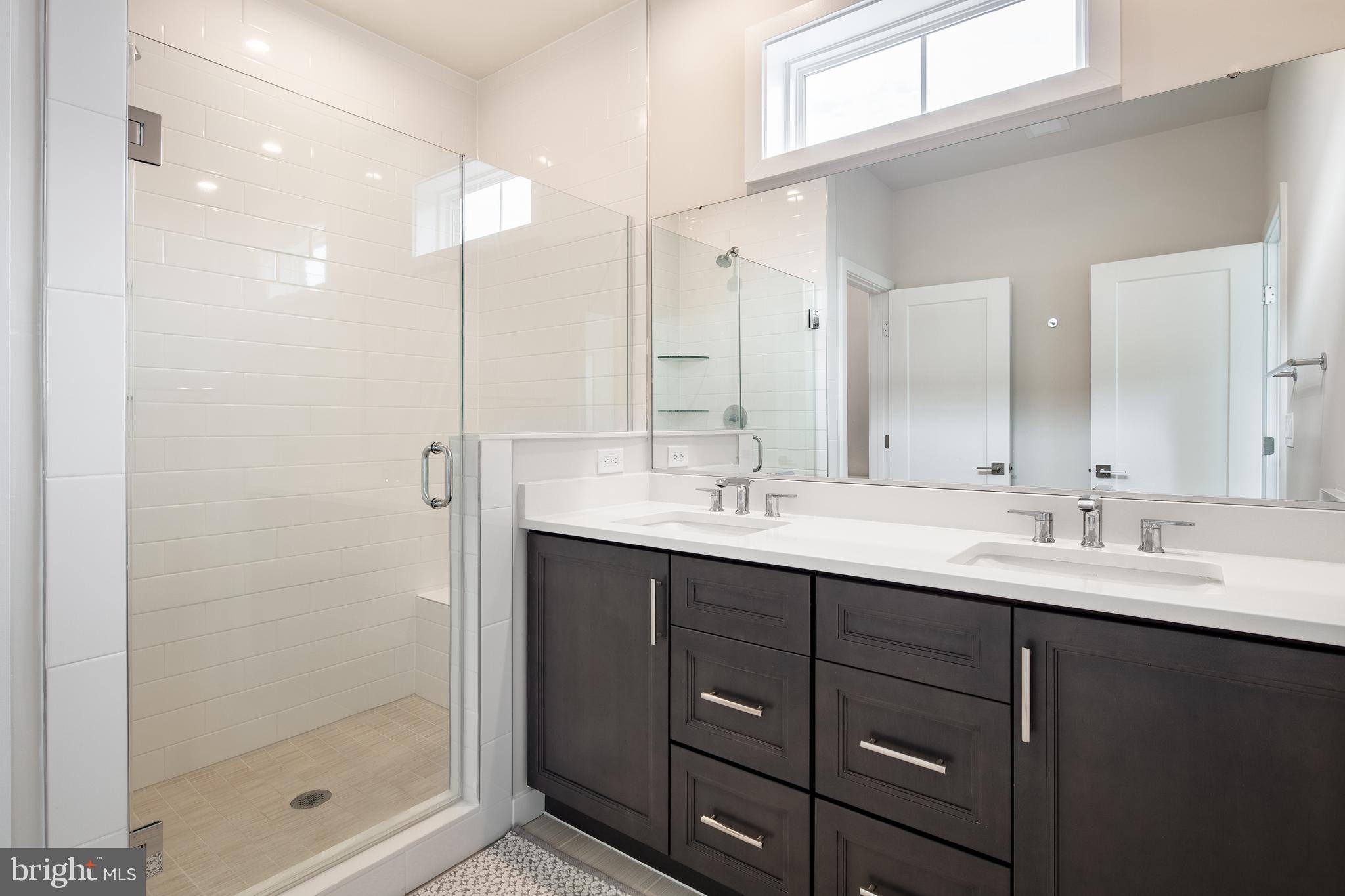 1770 Violet Ridge Place McLean, VA 22102 - Photo 34 of 54 a bathroom with a double vanity sink mirror and shower