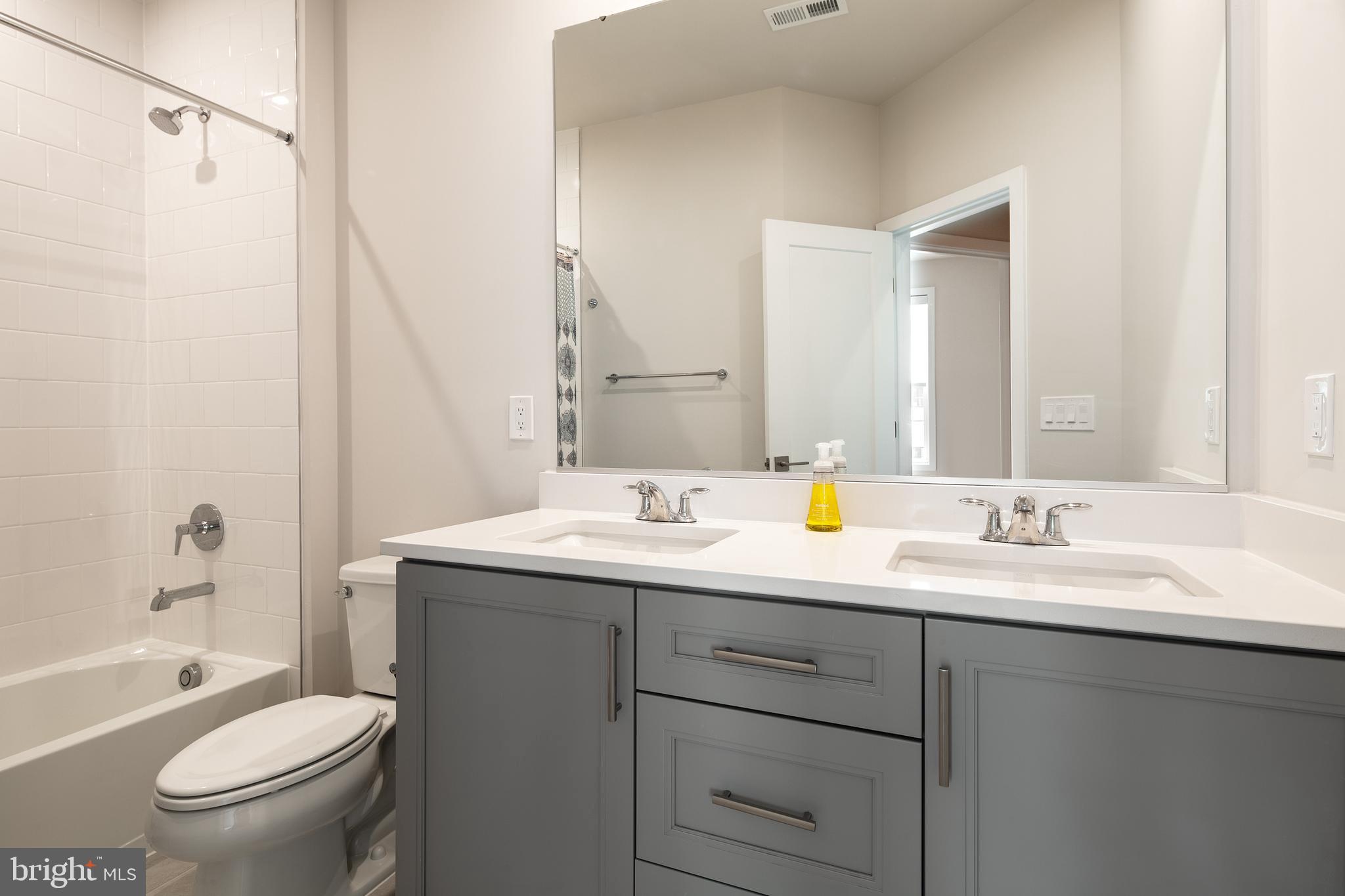 1770 Violet Ridge Place McLean, VA 22102 - Photo 41 of 54 a bathroom with a granite countertop sink toilet and shower