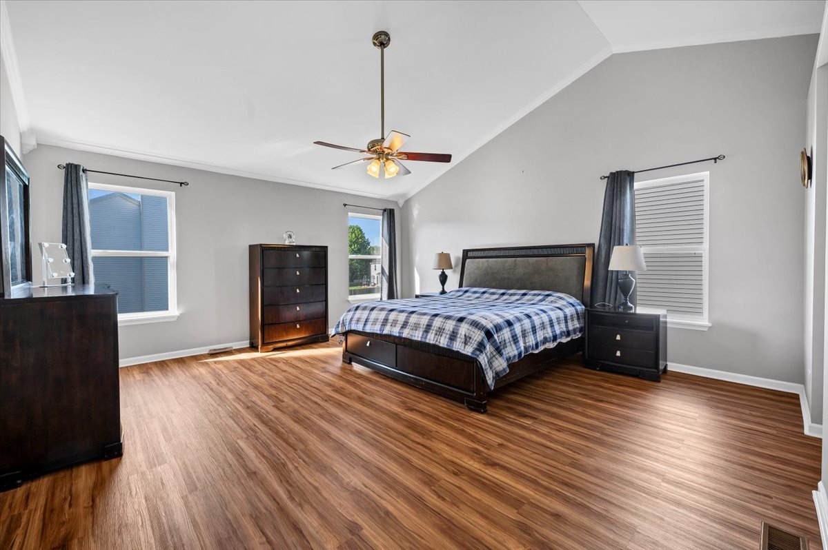 322 Zinnia Drive Romeoville, IL 60446 - Photo 16 of 42 a bedroom with a bed and wooden floor
