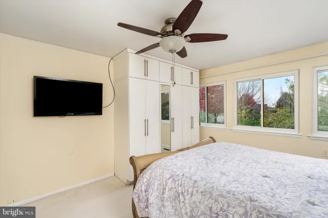 a bedroom with a bed and a large mirror with a flat tv screen
