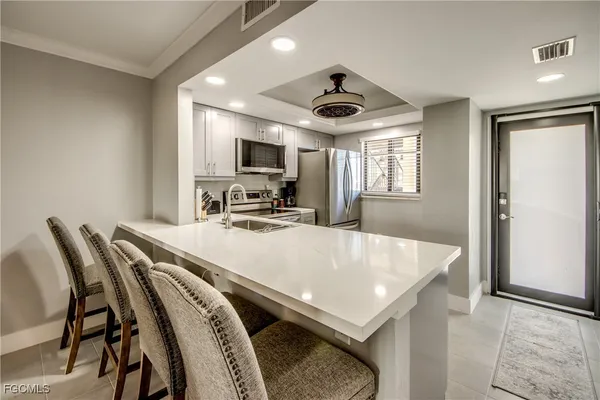 a kitchen with a sink stove and microwave