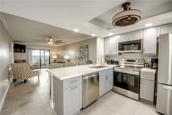 a kitchen with a sink a stove and cabinets
