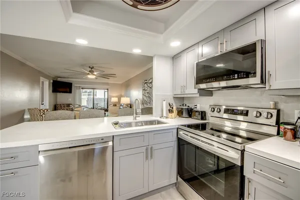 a kitchen with stainless steel appliances granite countertop a refrigerator sink and stove