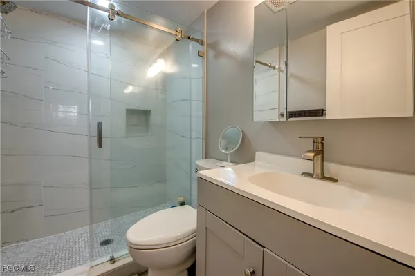 a bedroom with double bed and a flat tv screen on dresser