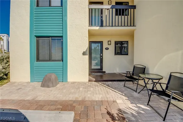 a view of a house with backyard and sitting area