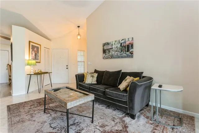 a living room with furniture a rug and a painting on the wall