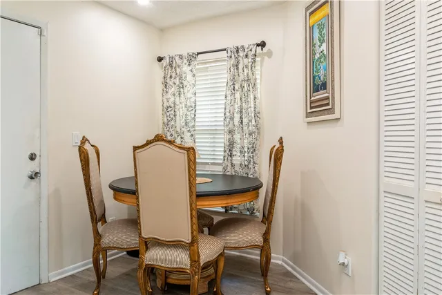 a view of a dining room with furniture and a window