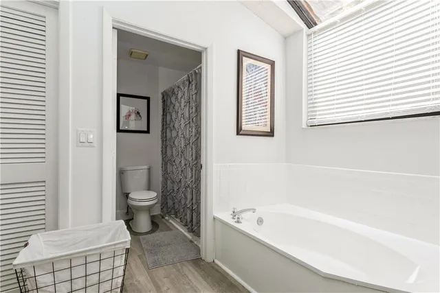 a bathroom with a toilet a sink and bathtub