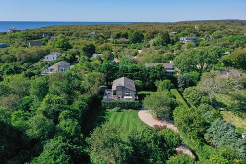 an aerial view of a house with a yard