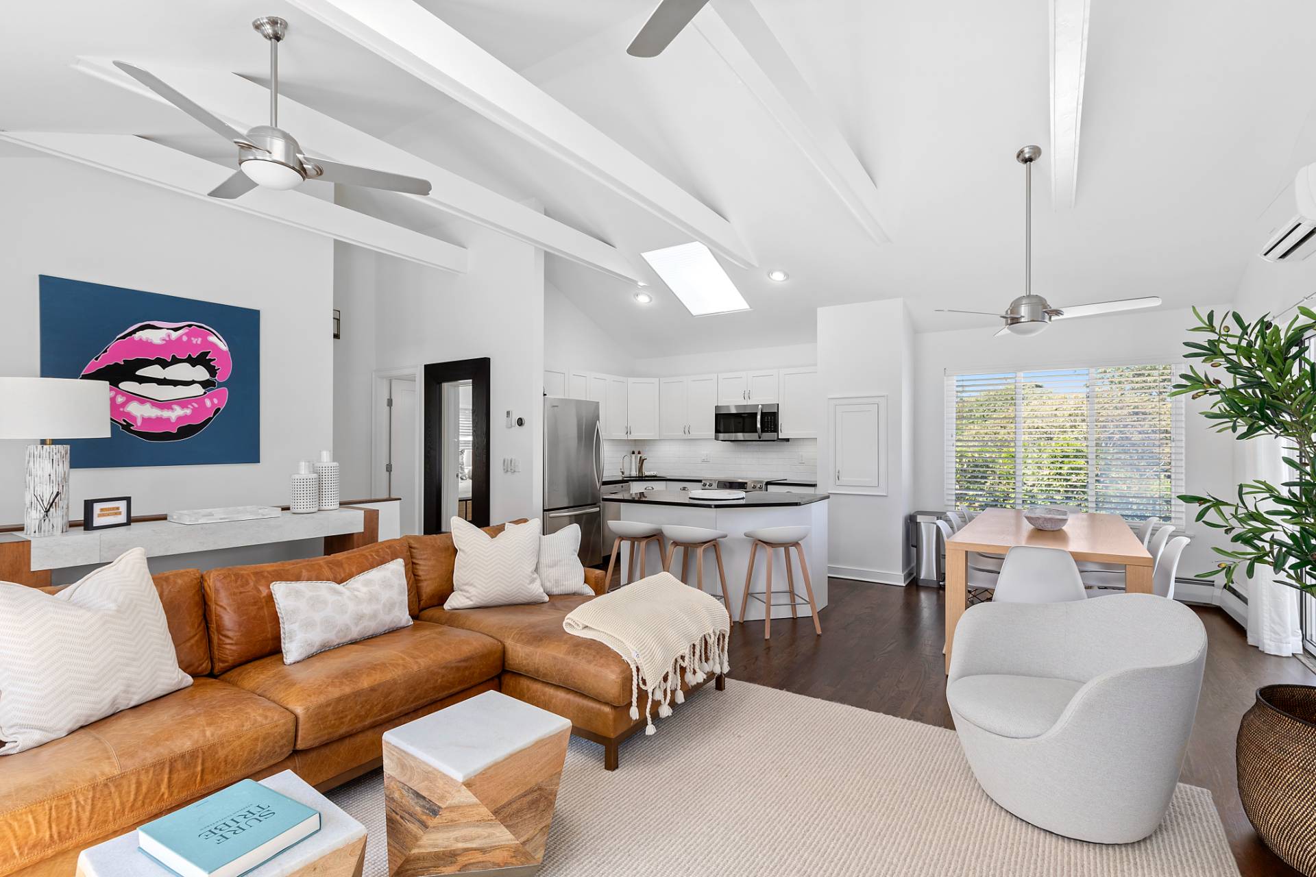 28 Ditch Plains Road Montauk, NY 11954 - Photo 4 of 30 a living room with furniture kitchen view and a chandelier