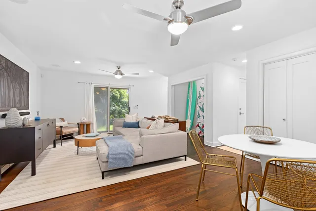 a living room with furniture a wooden floor and chandelier