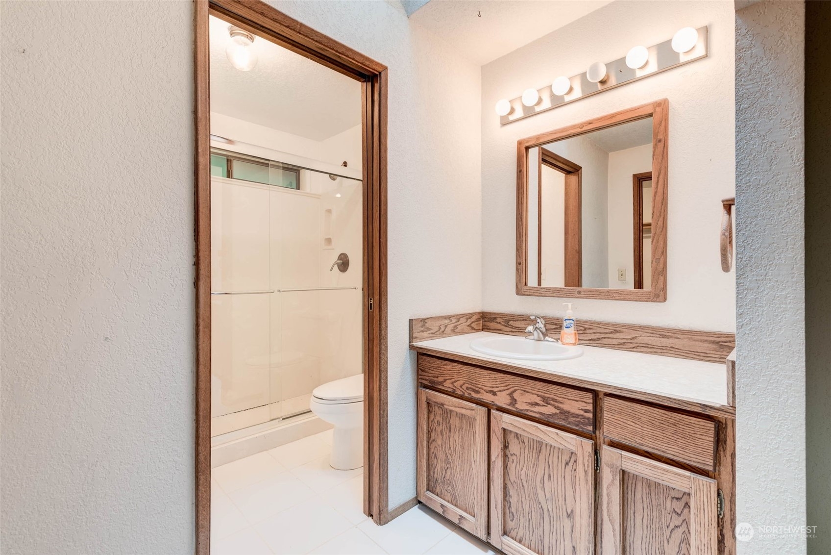 20821 30th Drive Southeast Bothell, WA 98021 - Photo 15 of 27 a bathroom with a sink a toilet and a mirror