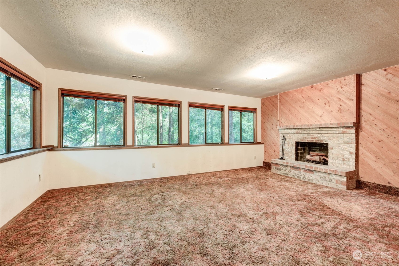 20821 30th Drive Southeast Bothell, WA 98021 - Photo 20 of 27 an empty room with floor to ceiling windows and fireplace