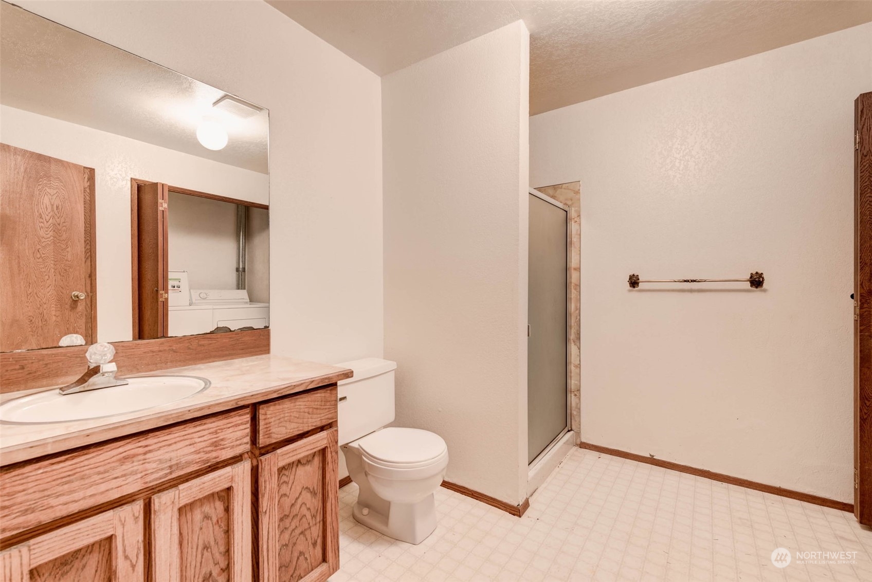 20821 30th Drive Southeast Bothell, WA 98021 - Photo 23 of 27 a bathroom with a sink a toilet a mirror and shower