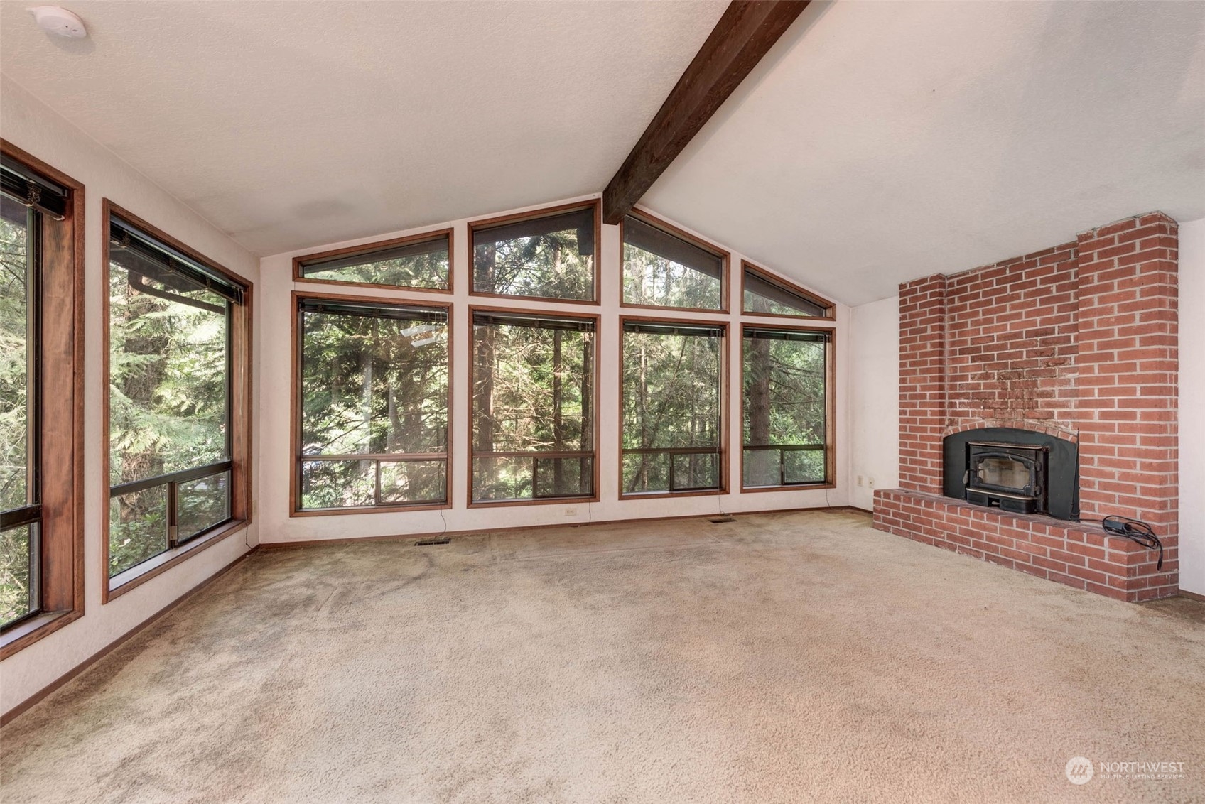 20821 30th Drive Southeast Bothell, WA 98021 - Photo 4 of 27 a view of an empty room with a fireplace and a window