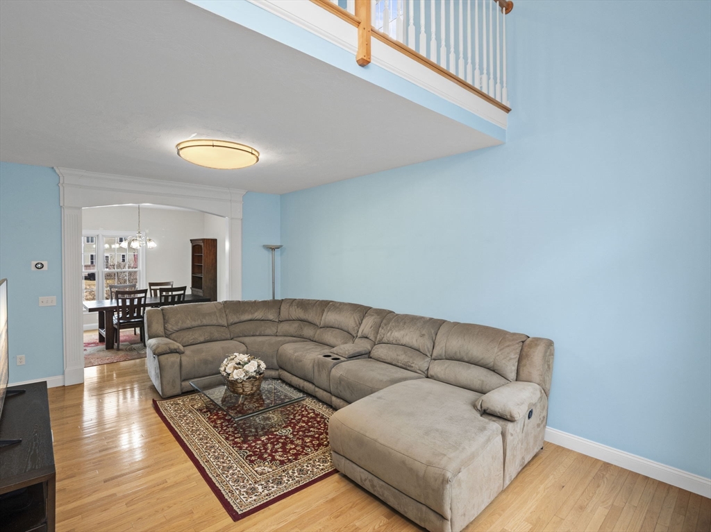 36 Knowlton Circle, Unit 1 Upton, MA 01568 - Photo 19 of 37 a living room with furniture and a wooden floor