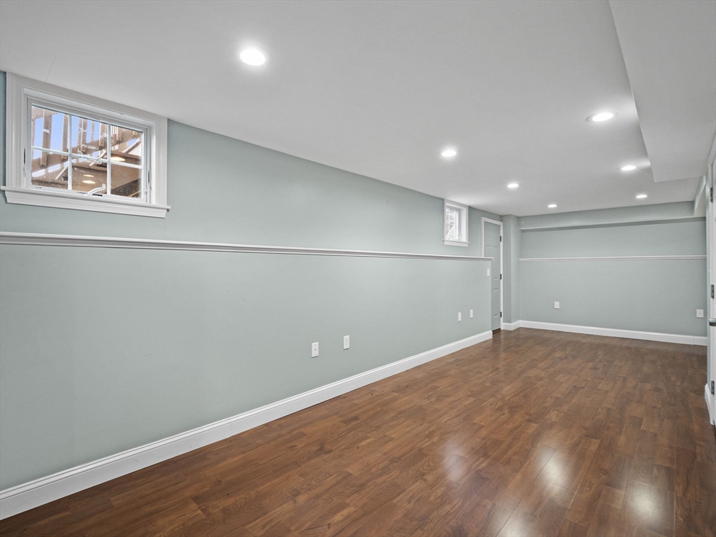 36 Knowlton Circle, Unit 1 Upton, MA 01568 - Photo 22 of 37 an empty room with wooden floor and windows