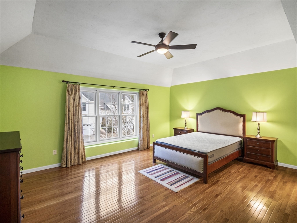 36 Knowlton Circle, Unit 1 Upton, MA 01568 - Photo 26 of 37 a spacious bedroom with a bed and wooden floor