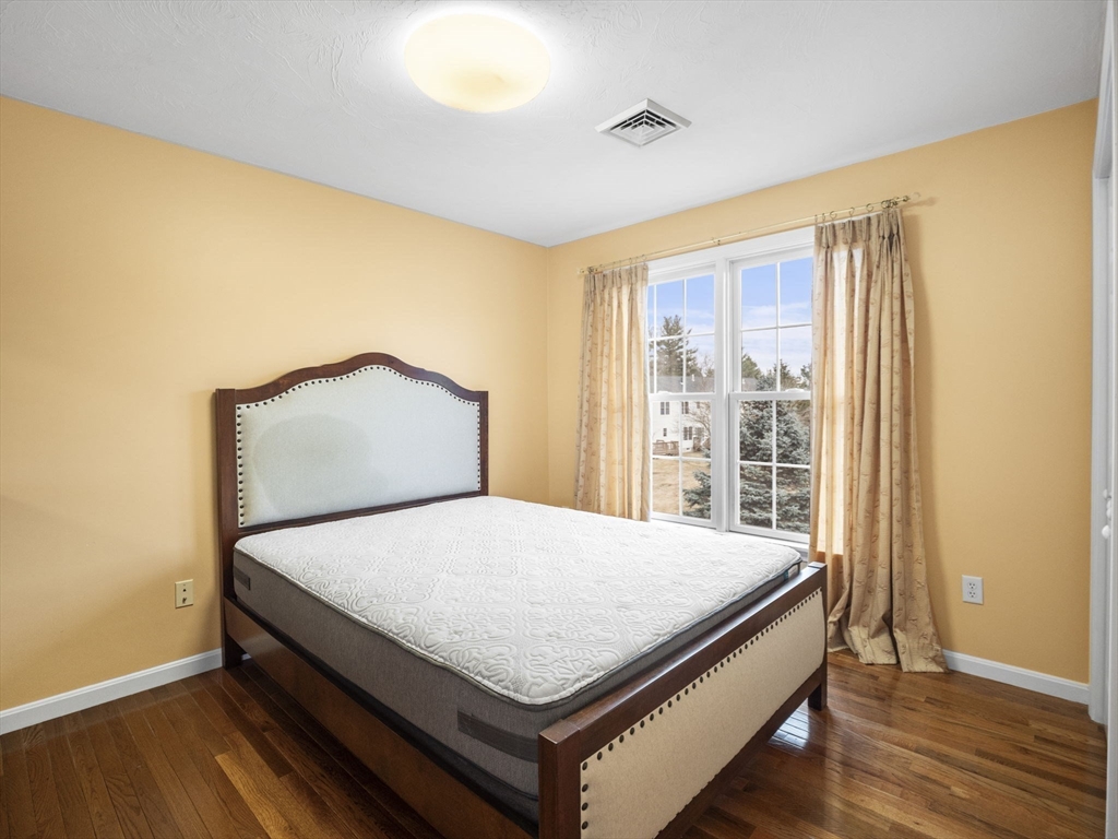 36 Knowlton Circle, Unit 1 Upton, MA 01568 - Photo 28 of 37 a bed sitting in a bedroom next to a window