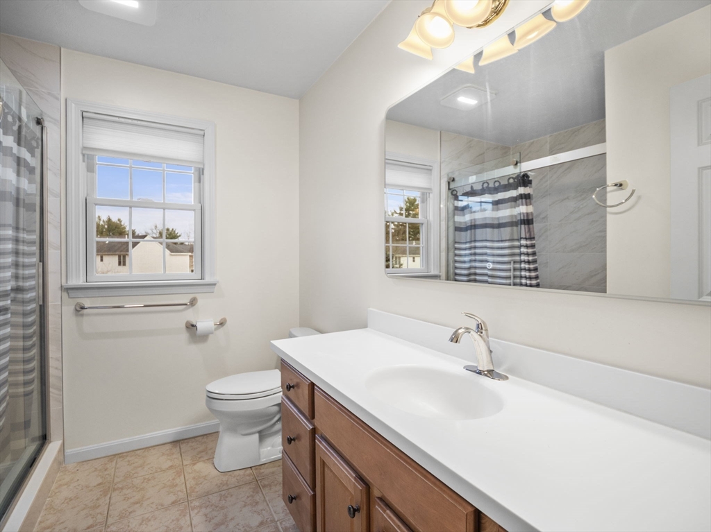 36 Knowlton Circle, Unit 1 Upton, MA 01568 - Photo 30 of 37 a bathroom with a toilet sink and mirror