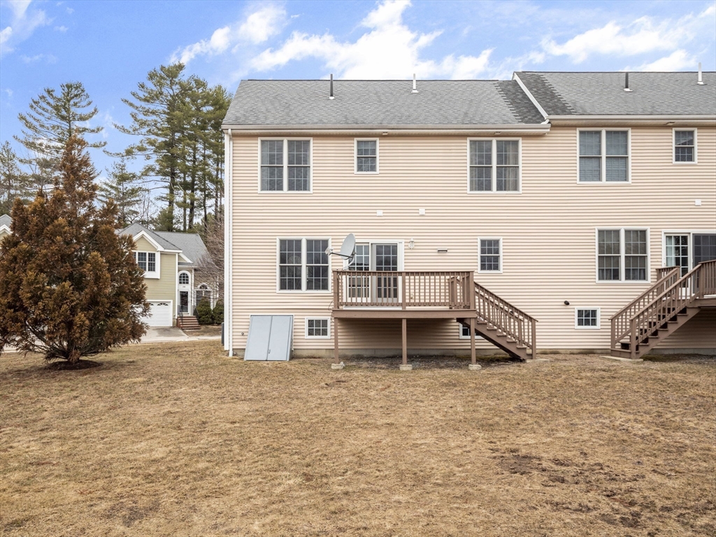 36 Knowlton Circle, Unit 1 Upton, MA 01568 - Photo 4 of 37 a view of a house with a yard and sitting area