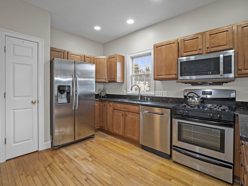 36 Knowlton Circle, Unit 1 Upton, MA 01568 - Photo 6 of 37 a kitchen with stainless steel appliances granite countertop a stove a refrigerator and a microwave