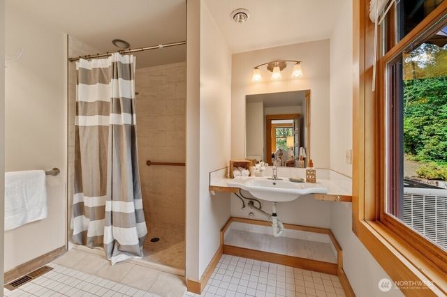 a bedroom with a large bed and wooden floor