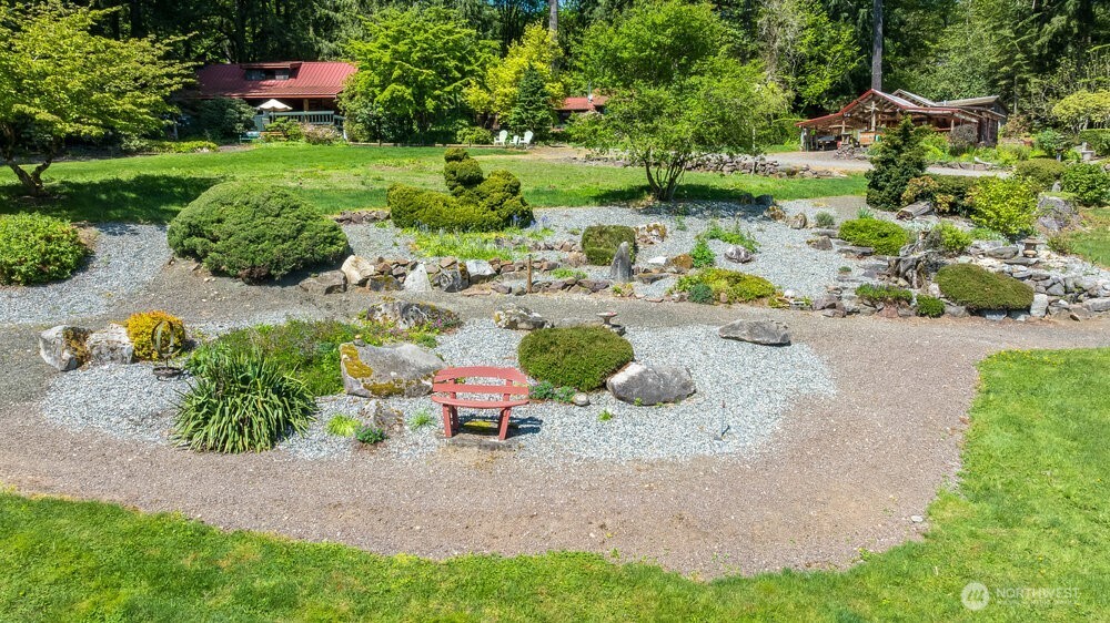 18013 West Snoqualmie Valley Road Northeast Duvall, WA 98019 - Photo 15 of 40 a garden with lots of trees and flowers