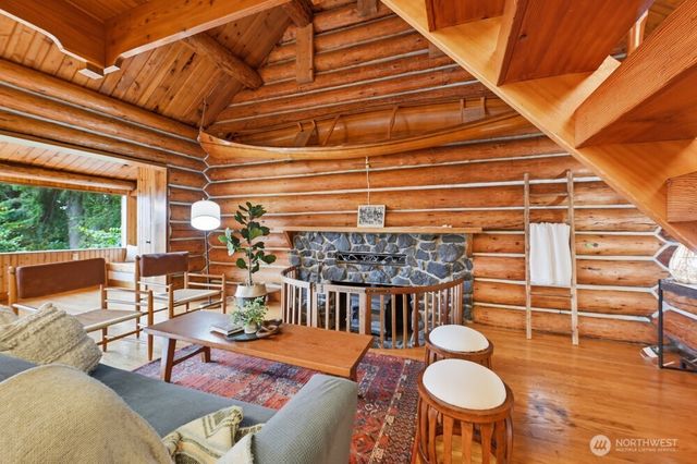 a kitchen with stainless steel appliances kitchen island granite countertop a table chairs in it and wooden floors