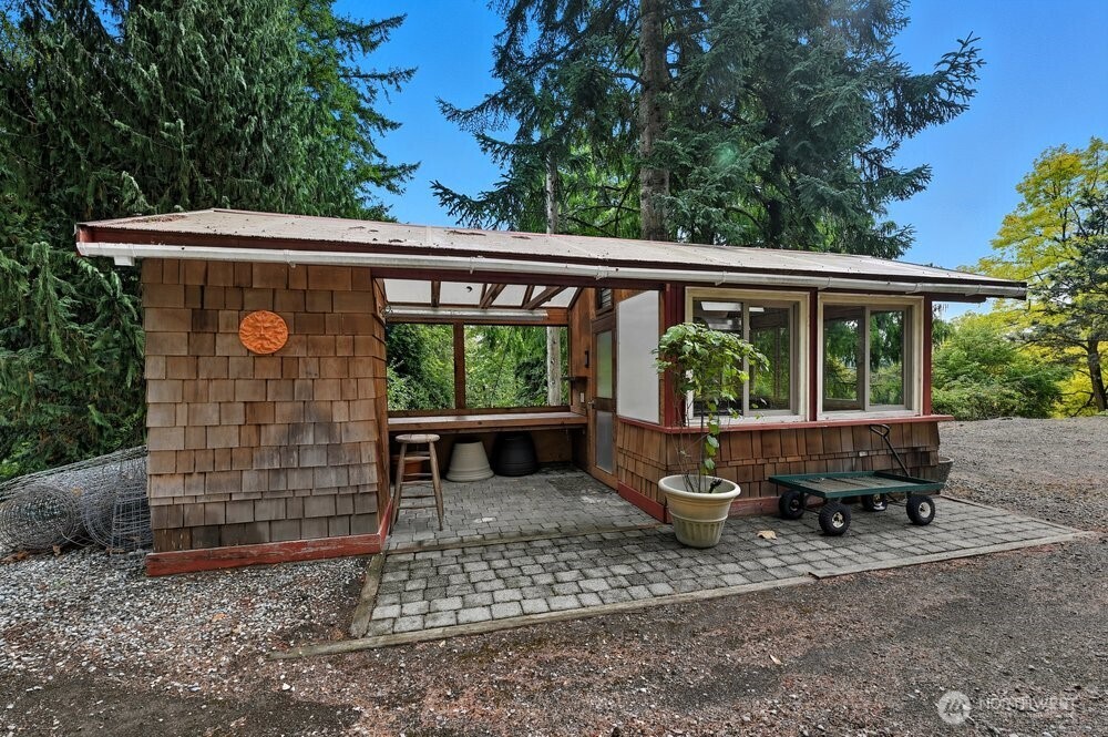 18013 West Snoqualmie Valley Road Northeast Duvall, WA 98019 - Photo 32 of 40 a backyard of a house with barbeque oven table and chairs