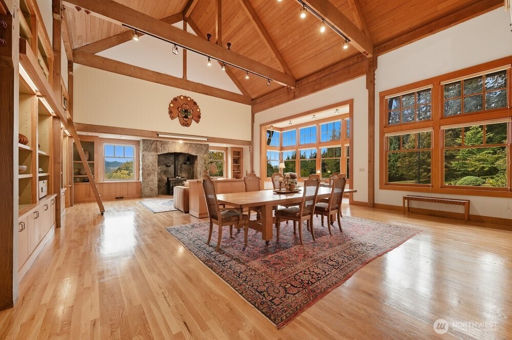18013 West Snoqualmie Valley Road Northeast Duvall, WA 98019 - Photo 8 of 40 a dining room with wooden floor a chandelier a glass table and chairs