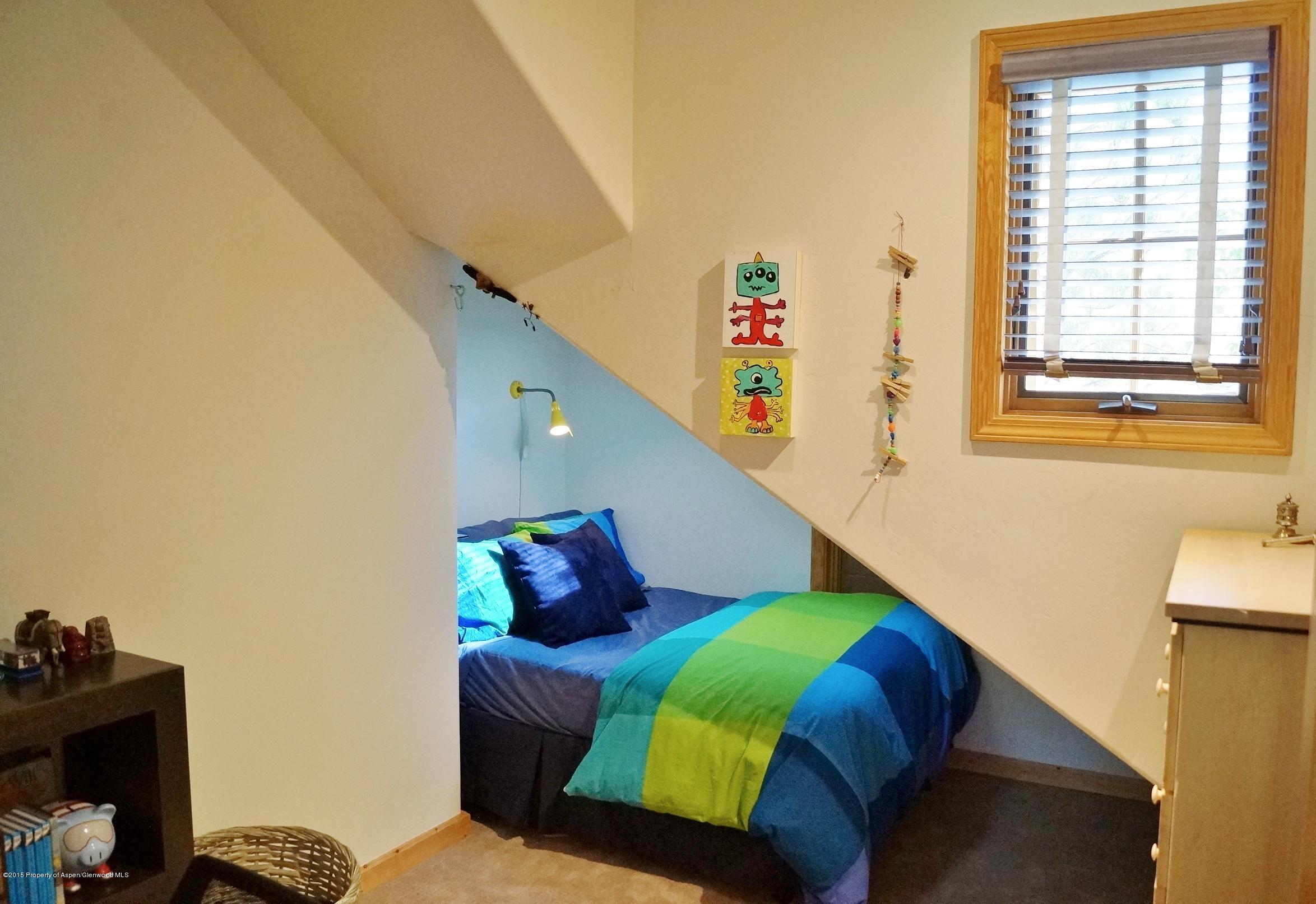 146 East Homestead Drive Basalt, CO 81621 - Photo 24 of 42 a bedroom with a bed and a window