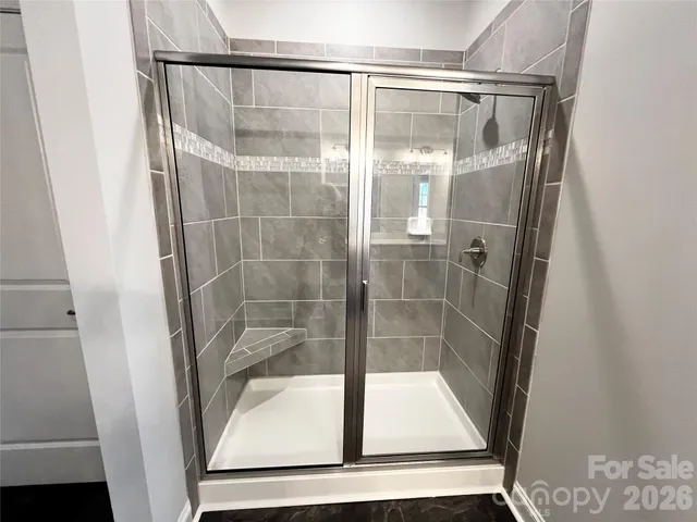 a bathroom with a glass shower door
