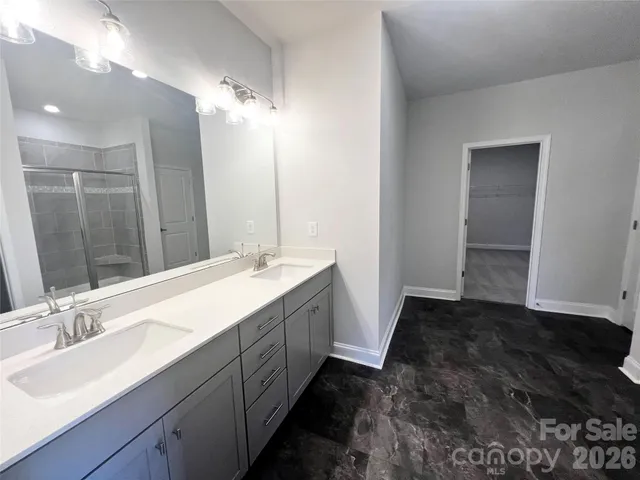 a bathroom with a double vanity sink and a mirror