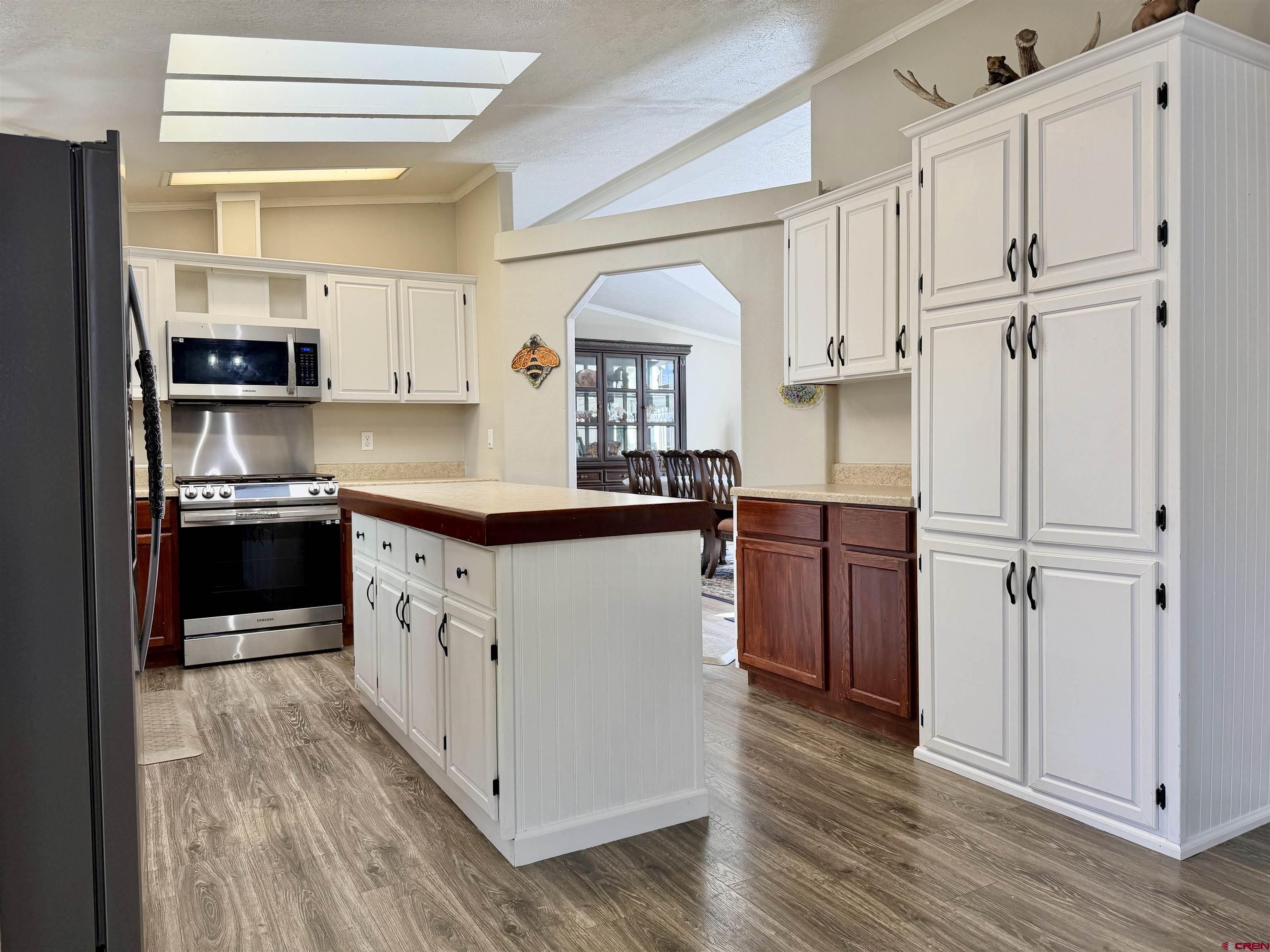 650 1725th Road Delta, CO 81416 - Photo 12 of 45 a kitchen with stainless steel appliances granite countertop a sink cabinets and wooden floor