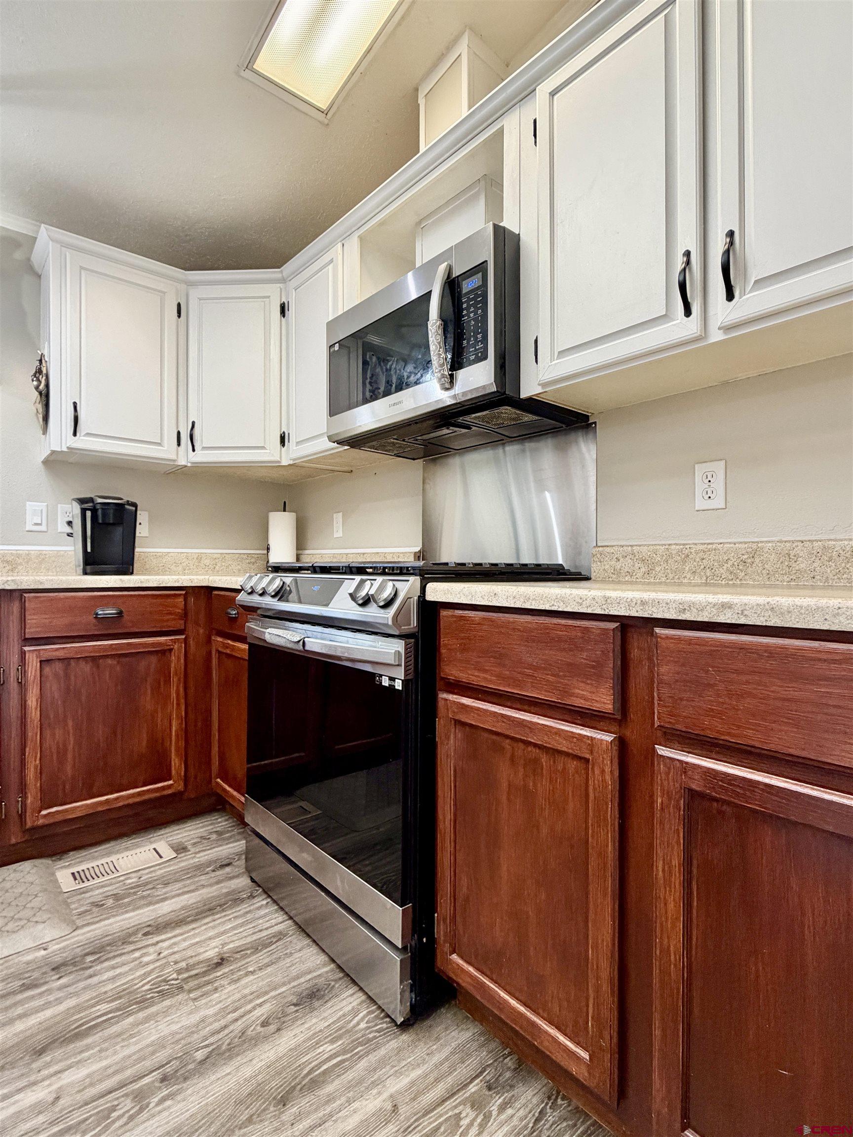 650 1725th Road Delta, CO 81416 - Photo 13 of 45 a kitchen with stainless steel appliances granite countertop a stove microwave and cabinets