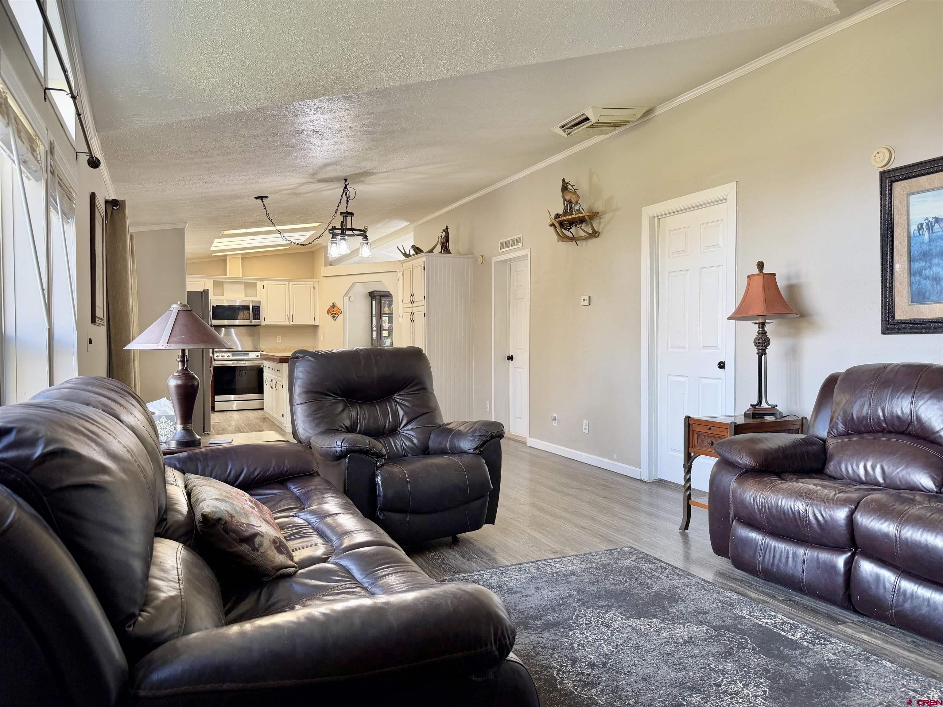 650 1725th Road Delta, CO 81416 - Photo 19 of 45 a living room with furniture a ceiling fan and a window