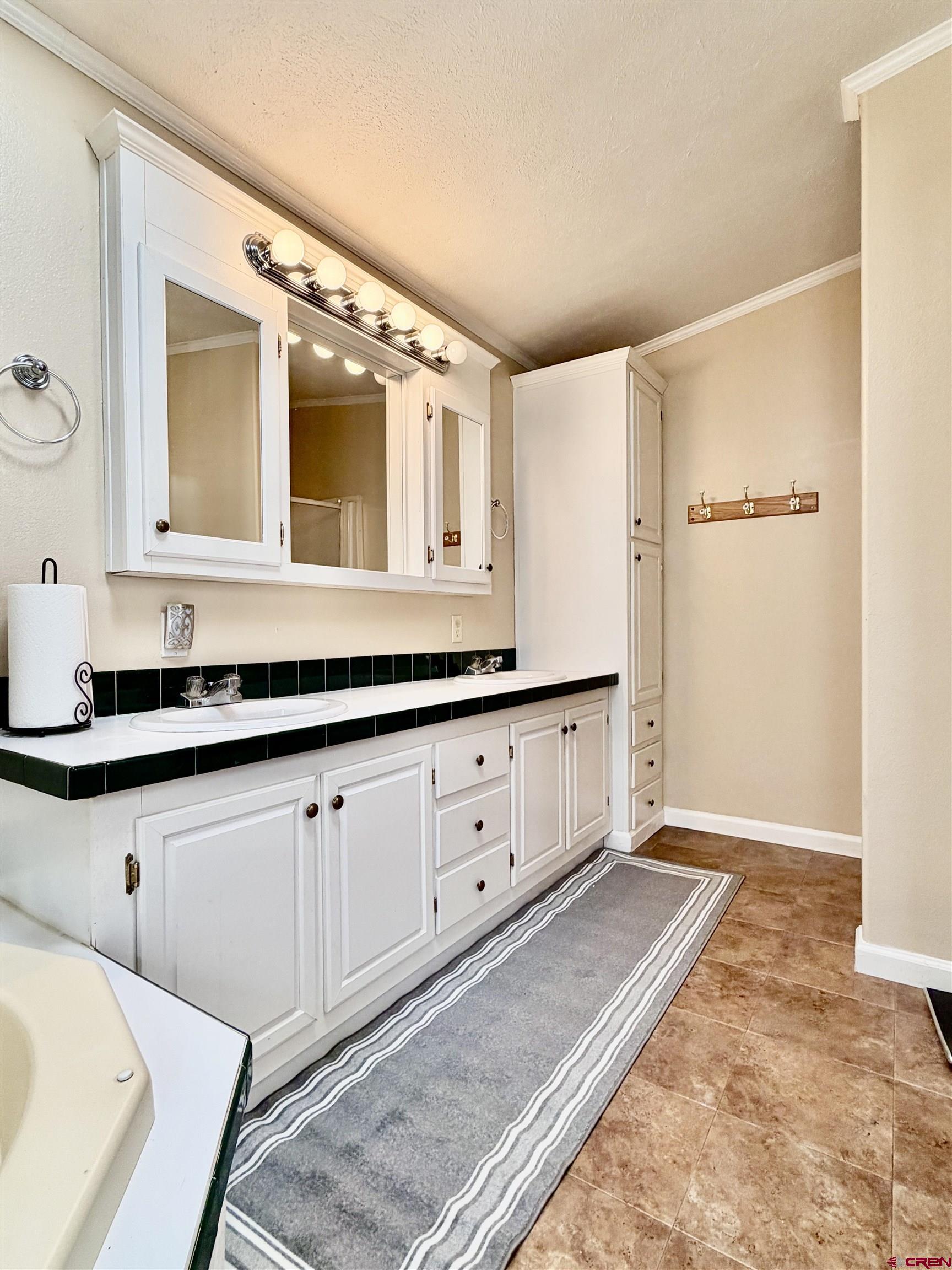 650 1725th Road Delta, CO 81416 - Photo 23 of 45 a spacious bathroom with a double vanity sink a mirror and a shower