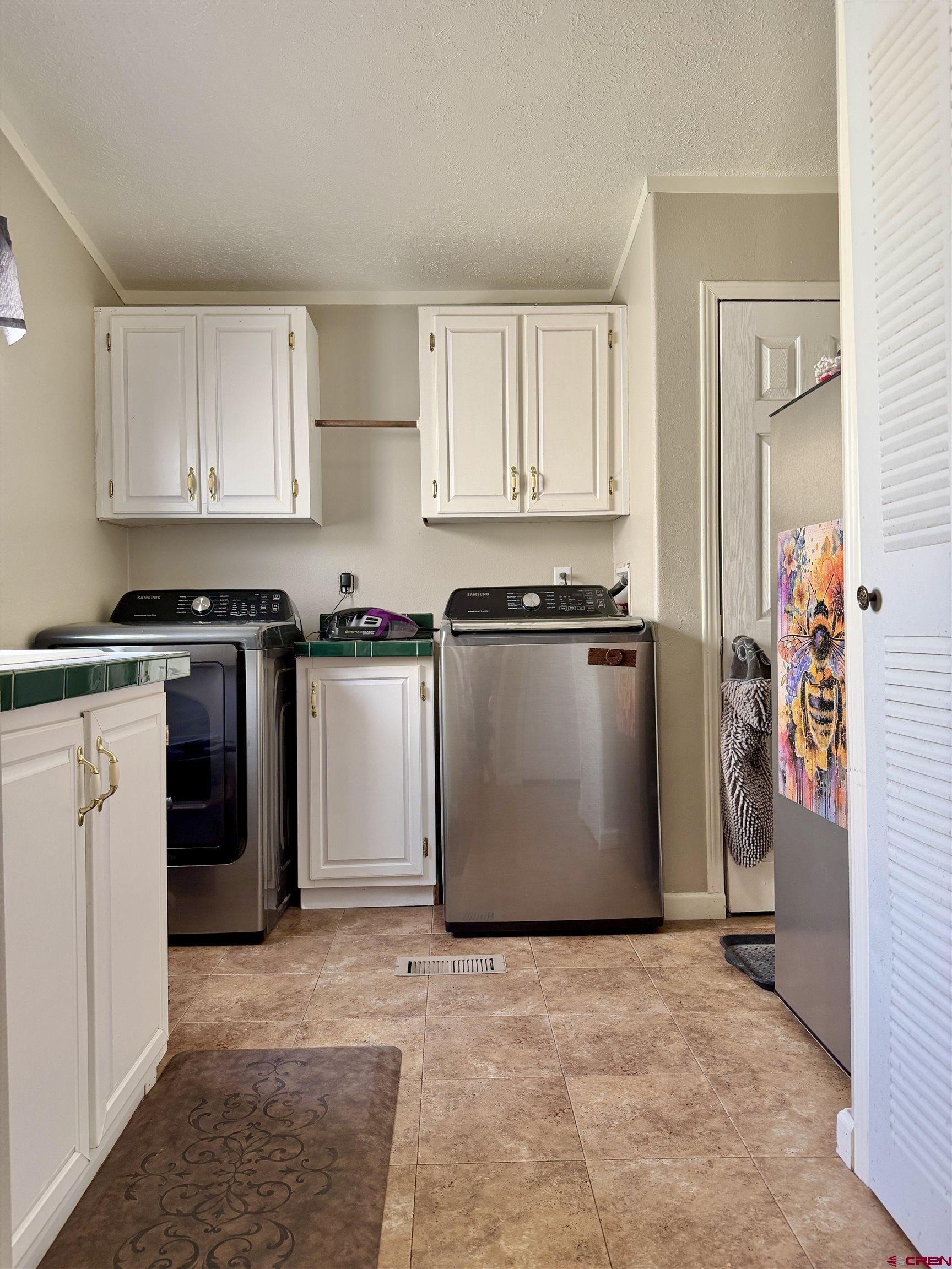 650 1725th Road Delta, CO 81416 - Photo 31 of 45 a kitchen with stainless steel appliances granite countertop a stove a refrigerator a sink and dishwasher with white cabinets